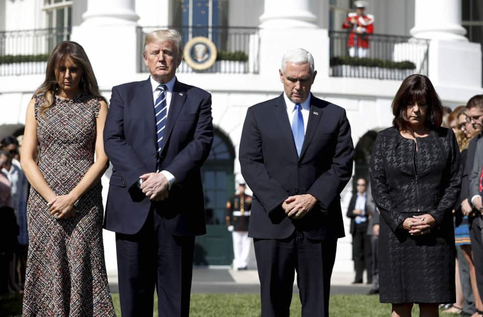 President Donald Trump and first lady Melania Trump stand with vice president Mike Pence and his wife Karen during a moment of silence to remember the victims of the mass shooting in Las Vegas.