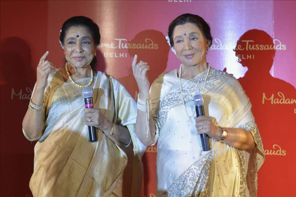 Veteran singer Asha Bhosle with her wax statue that was unveiled at the Madame Tussauds museum in New Delhi.