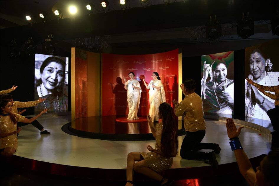 Veteran singer Asha Bhosle with her wax statue that was unveiled at the Madame Tussauds museum in New Delhi.