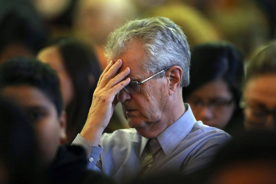 A man mourns during an interfaith memorial service for victims of the Route 91 music festival mass shooting outside the Mandalay Bay Resort and Casino in Las Vegas.