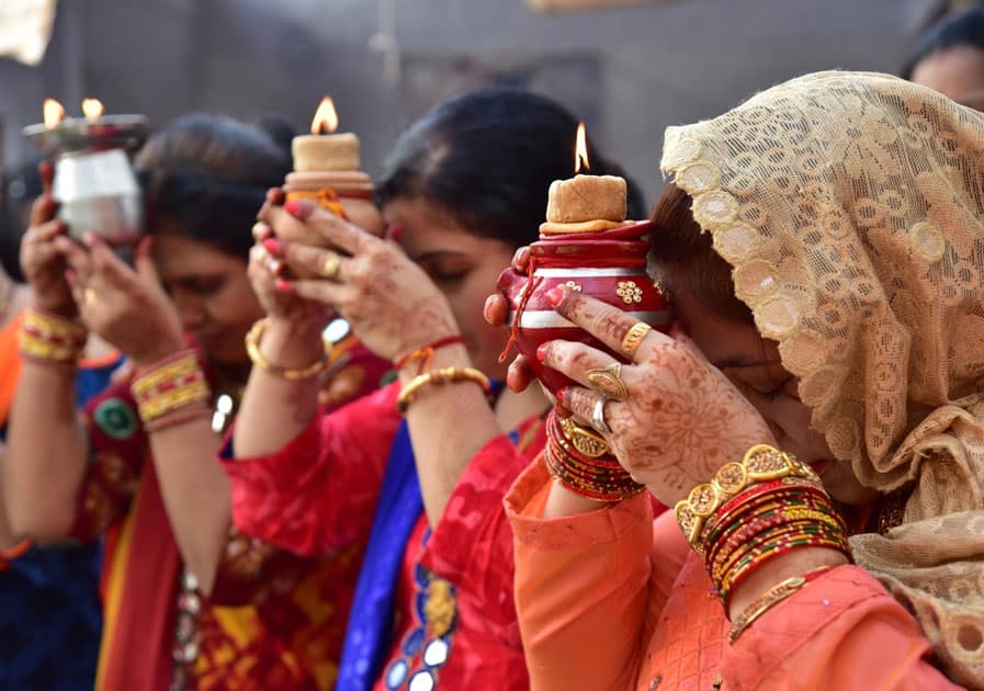 Women perform rituals related to Karva Chauth in Bikaner.