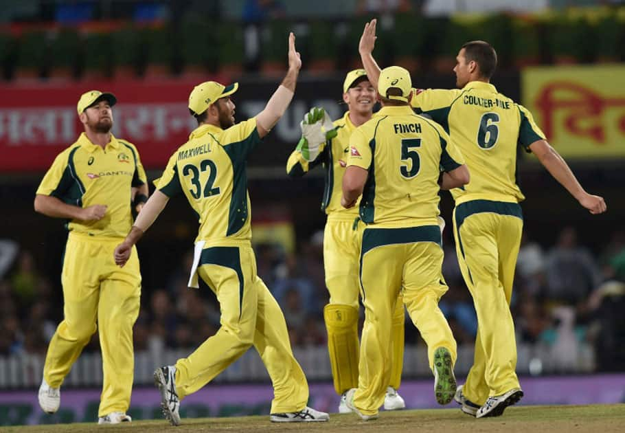 Australian bowler Nathan Coulter-Nile jubiliate with his teammates after dismissed Indian batsman R.Sharma during the 1st T20 cricket match between India and Australia in Ranchi.