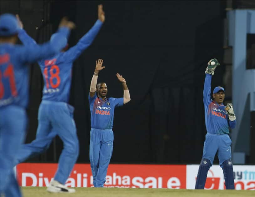 Indian players MS Dhoni and Shikhar Dhwan during the second T20 match between India and Australia at Barsapara Cricket Stadium in Guwahati.