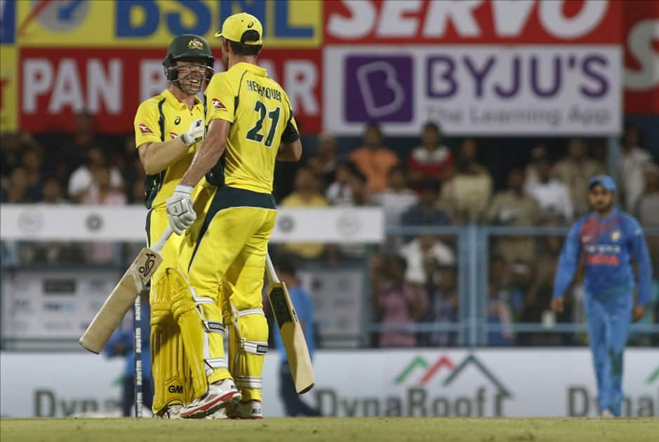 Moises Henriques and Travis Head of Australia celebrate after winning the second T20 match Against India at Barsapara Cricket Stadium in Guwahati.