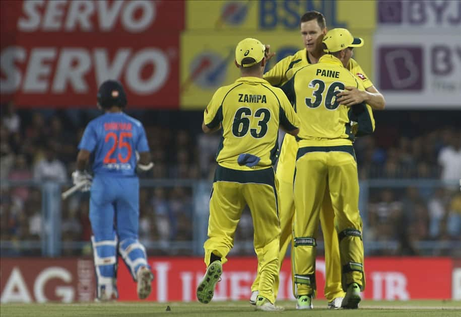 Australia's Jason Behrendorff, celebrates fall of Rohit Sharma's wicket during the second T20 match between India and Australia at Barsapara Cricket Stadium in Guwahati.