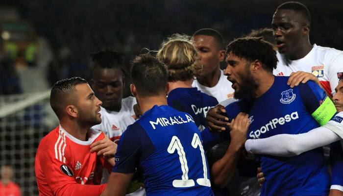 Watch: Everton fan holding child &#039;punches&#039; Lyon player during Europa League