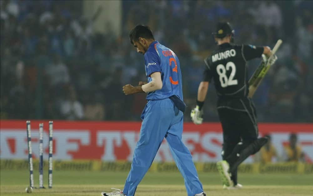 Yuzvendra Chahal of India celebrates fall of Colin Munro's wicket during the third ODI match between India and New Zealand at Green Park Stadium in Kanpur.