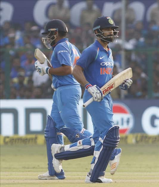 Virat Kohli and Rohit Sharma of India celebrates his half century during the third ODI match between India and New Zealand at Green Park Stadium in Kanpur.