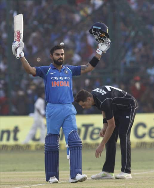 Virat Kohli of India celebrates his century during the third ODI match between India and New Zealand at Green Park Stadium in Kanpur.