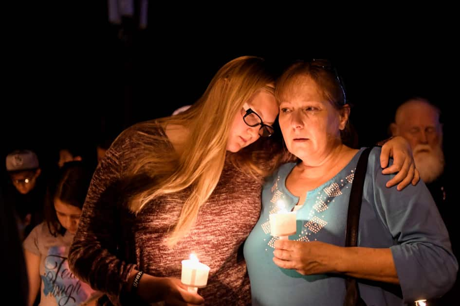 Local residents embrace during a candlelight vigil for victims of a mass shooting in a church in Sutherland Springs, Texas.