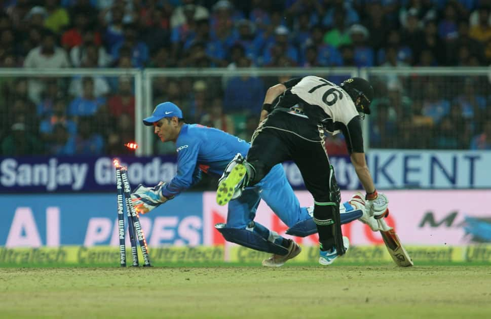 MS Dhoni of India dislodges the stumps during the third and final T20 International match