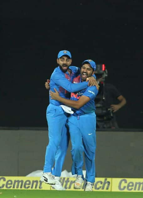 Indian skipper Virat Kohli along with Rohit Sharma celebrates fall of Colin Munro's wicket