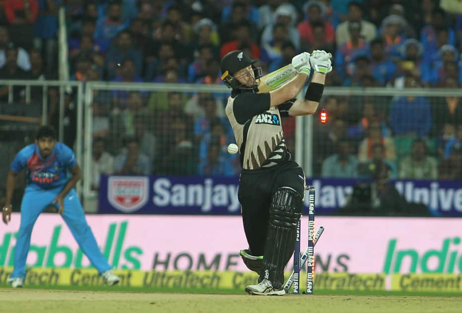 Martin Guptill of New Zealand is bowled out by India's Bhuvneshwar Kumar during the third and final T20 International match