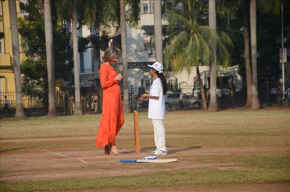 Belgium's King Philippe, Queen Mathilde and former Indian cricketer Virender Sehwag play cricket with under privileged children during an event hosted by UNICEF in Mumbai.