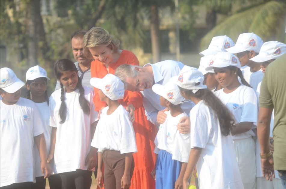 Belgium's King Philippe and Queen Mathilde and former Indian cricketer Virender Sehwag play cricket with under privileged children during an event hosted by UNICEF in Mumbai.