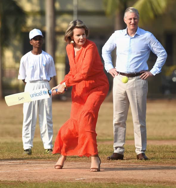 Belgium's Queen Mathilde and King Philippe play cricket at the Oval maidan, in Mumbai.