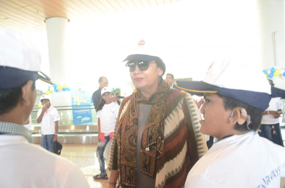 Actress Shabana Azmi meets differently abled children during a programme organised to announce 'Flight of Fantasy' by Jet Airways ahead of Children's Day at Chhatrapati Shivaji International Airport in Mumbai.