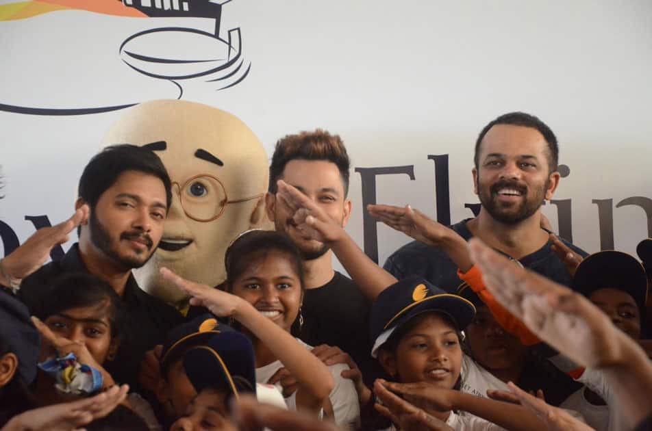 Filmmaker Rohit Shetty and actors Shreyas Talpade and Kunal Khemu with children during a programme organised to announce 'Flight of Fantasy' by Jet Airways ahead of Children's Day at Chhatrapati Shivaji International Airport in Mumbai.