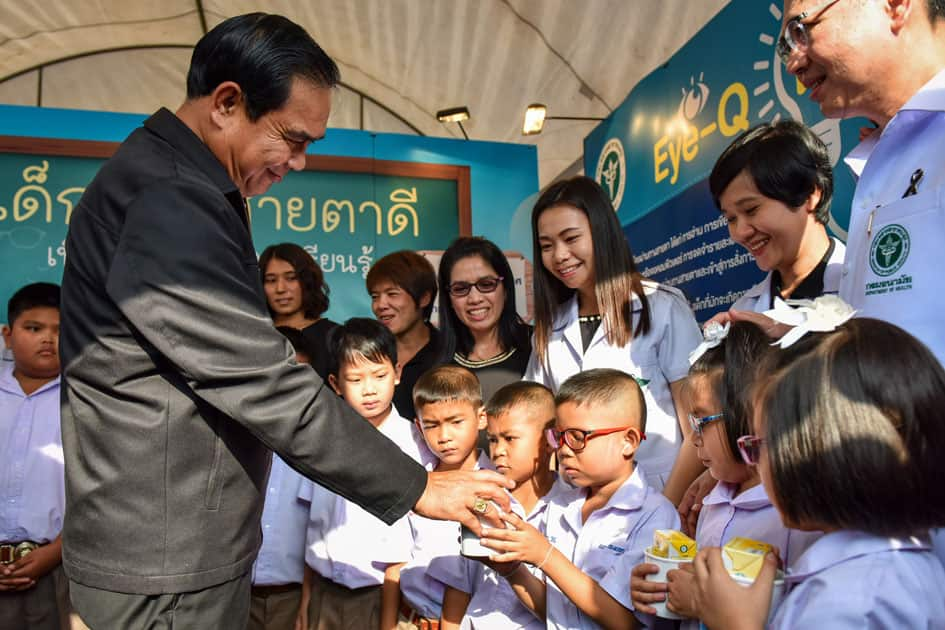 Thai Prime Minister Prayuth Chan-ocha gives presents to kids during a Children's Day celebration at the Sanam Suea Pa Park in Bangkok, Thailand.