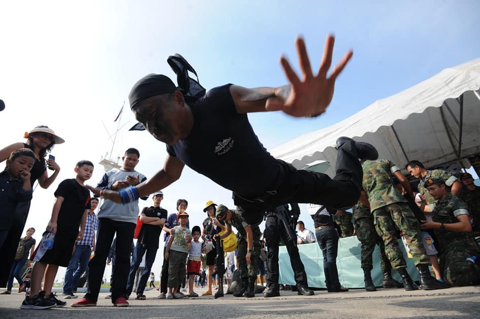 Children and their parents watch a military stunt show during a Children's Day public-opening event at the Royal Thai Naval Academy in Bangkok, Thailand.