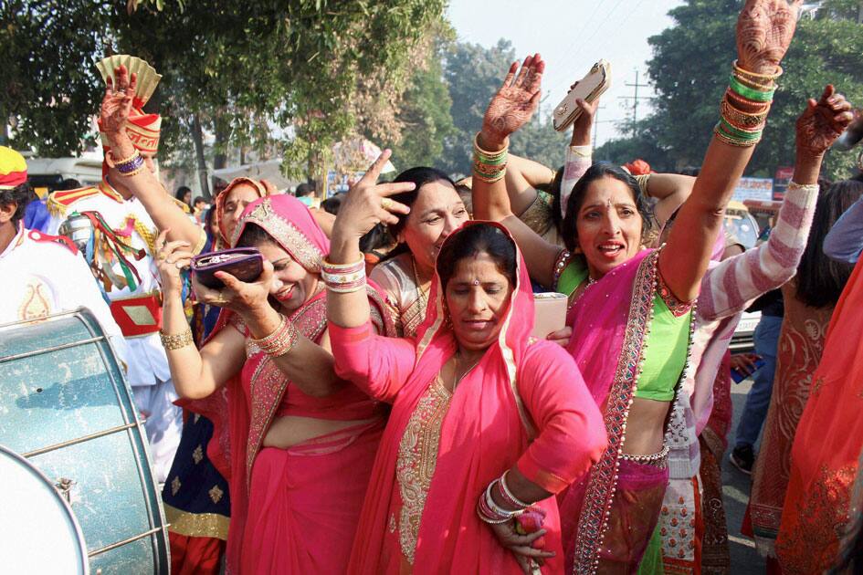 Family members and relatives dance during speedster Bhuvneshwar Kumar's marriage procession in Meerut.