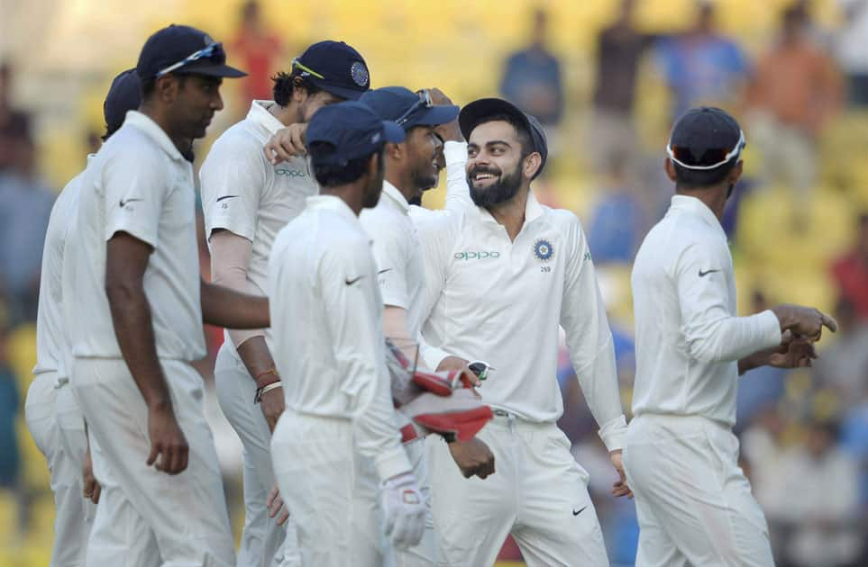 Indian captain Virat Kohli along with teammates return back to the pavalion at the end of the 3rd day's play of the 2nd cricket test match against Sri Lanka in Nagpur.