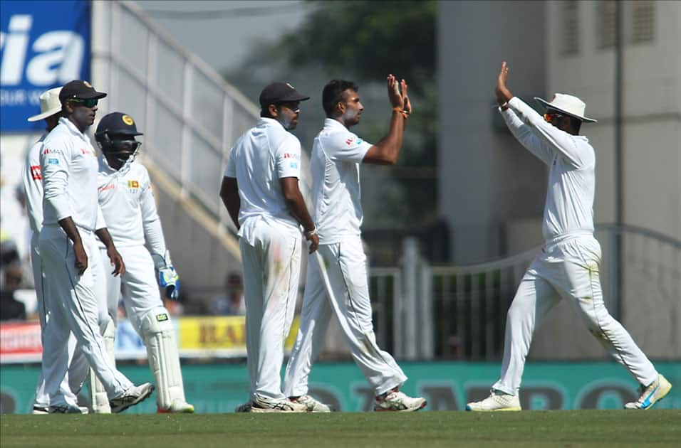 Sri Lanka's Dasun Shanaka celebrates fall of a wicket of India's Cheteshwar Pujara with teammates on Day 3 of the second test match between India and Sri Lanka at Vidarbha Cricket Association Stadium in Nagpur.