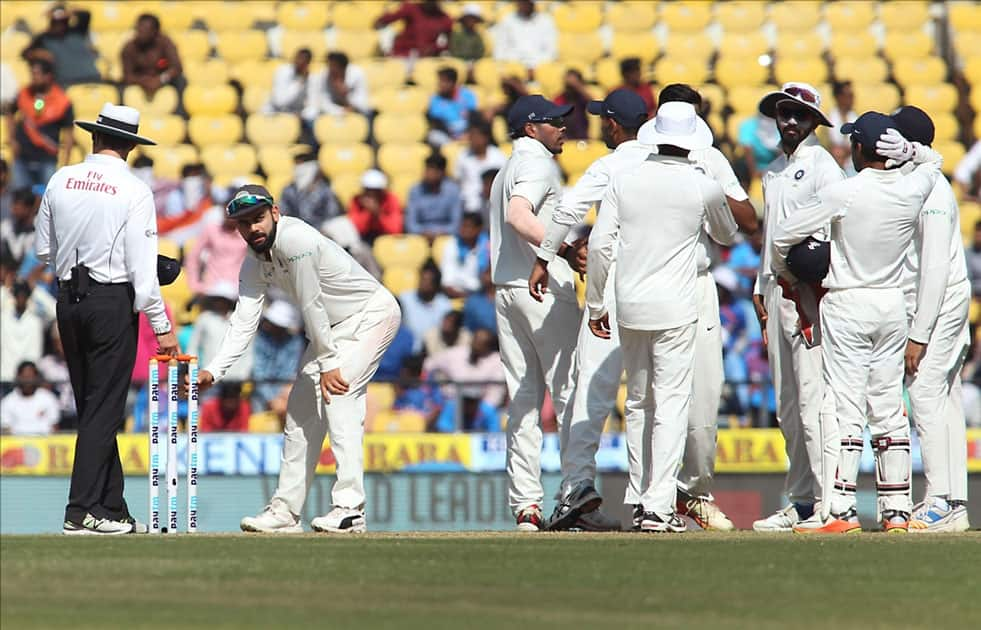 Indian skipper Virat Kohli waits for the decision of the third umpire Nigel Llong before plucking the wickets on Day 4 of the second test match against Sri Lanka at Vidarbha Cricket Association Stadium in Nagpur.