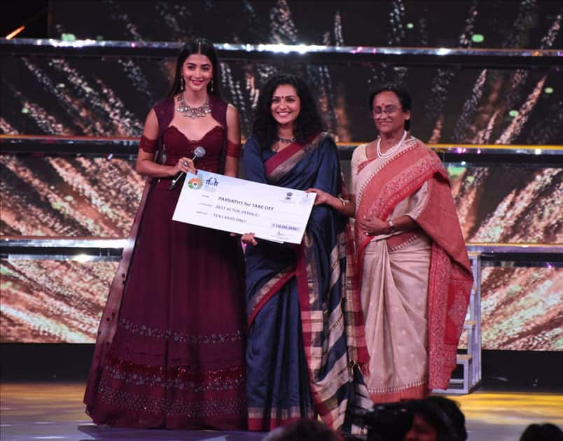 Uttar Pradesh Tourism Minister Prof. Rita Bahuguna Joshi presents the Silver Peacock Award for the Best Actor (Female) to Parvathy Thiruvoth Kottuvatta for the Malayalam film 