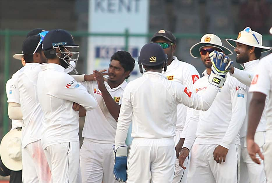 Sri Lanka's Lakshan Sandakan celebrates fall of a wicket of India's Ajinkya Rahane with teammates on Day 1 of the third test match between India and Sri Lanka at Feroz Shah Kotla Stadium in New Delhi.