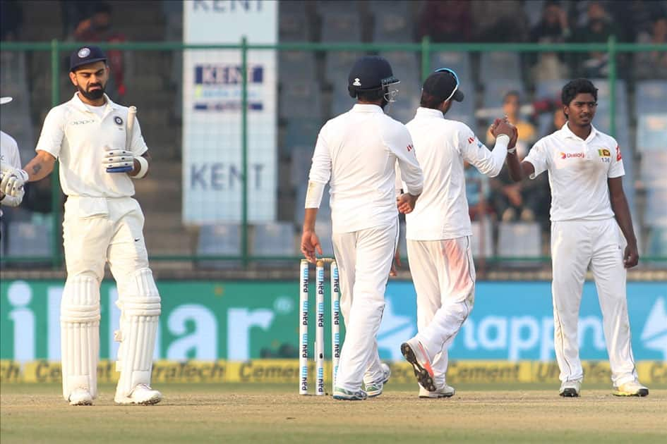 Sri Lanka's Lakshan Sandakan celebrates fall of a wicket of India's Murali Vijay with teammates on Day 1 of the third test match between India and Sri Lanka at Feroz Shah Kotla Stadium in New Delhi.