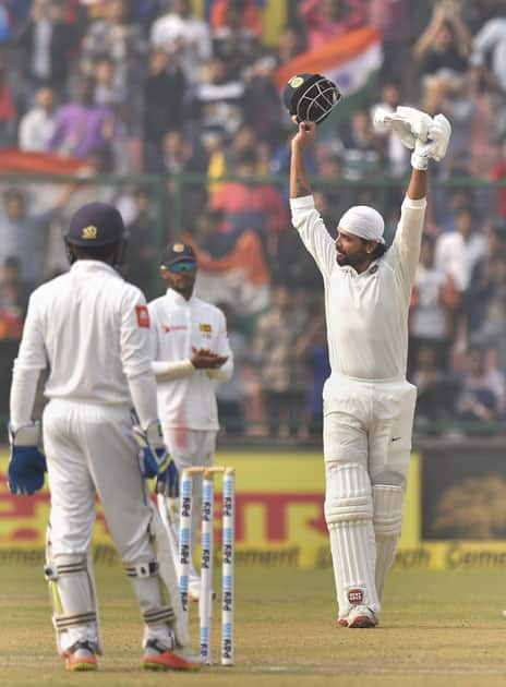 Indian cricketer Murali Vijay celebrates after completing his century against Sri Lanka during the first day of the third cricket test match at Feroz Shah Kotla, in New Delhi.