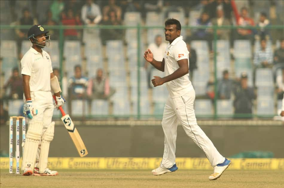 Sri Lanka's Lahiru Gamage celebrates fall of a wicket of India's Cheteshwar Pujara on Day 1 of the third test match between India and Sri Lanka at Feroz Shah Kotla Stadium in New Delhi.