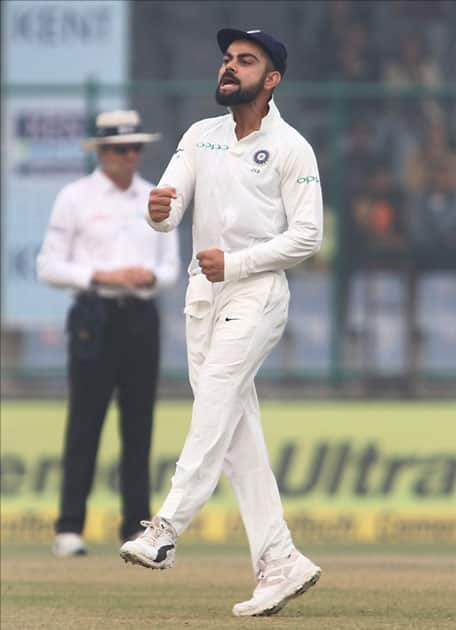 Indian captain Virat Kohli celebrates fall of Dimuth Karunaratne's wicket on Day 2 of the third test match between India and Sri Lanka at Feroz Shah Kotla Stadium in New Delhi.