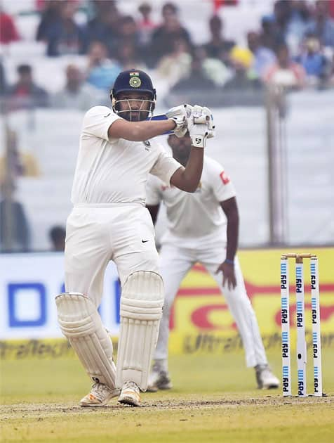 India's Rohit Sharma plays a shot against Sri Lanka during the second day of the third cricket test match at Feroz Shah Kotla, in New Delhi.