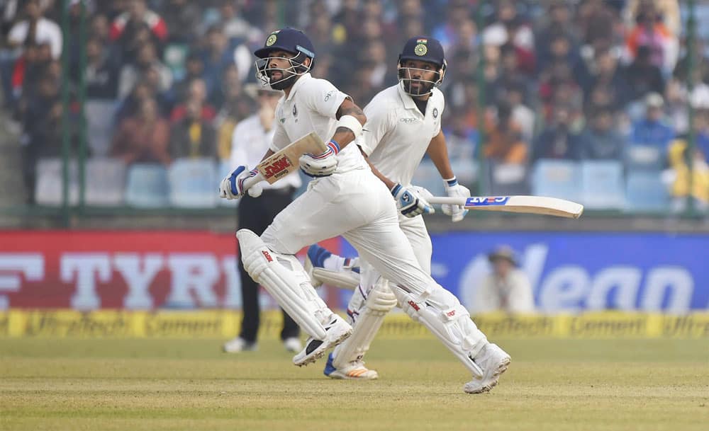 India's Virat Kohli and Rohit Sharma take runs during the second day of the third cricket test match against Sri Lanka, at Feroz Shah Kotla, in New Delhi.