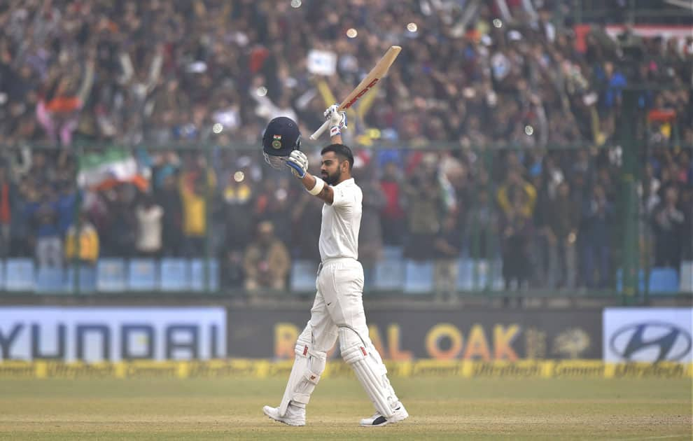 India's Virat Kohli celebrates his double century against Sri Lanka during the second day of the third cricket test match at Feroz Shah Kotla, in New Delhi.