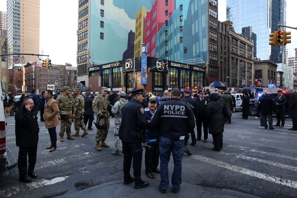 New York Police Department (NYPD) officers stand guard near Port Authority Bus Terminal after reports of an explosion in New York.