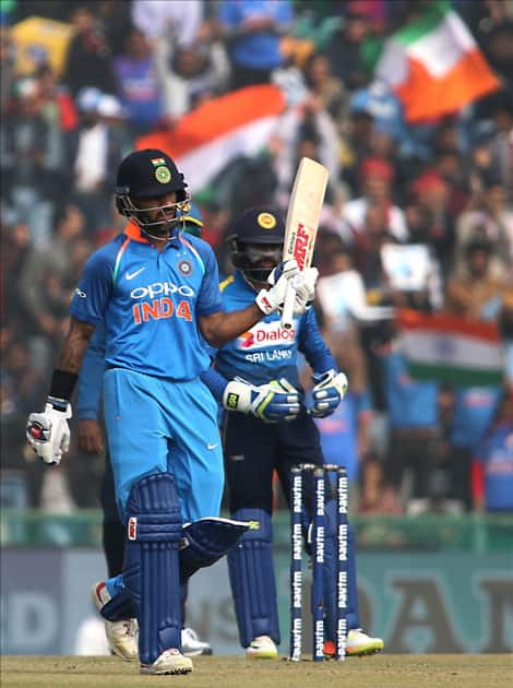 India's Shikhar Dhawan celebrates his half-century during the 2nd One Day International (ODI) match between India and Sri Lanka at Punjab Cricket Association IS Bindra Stadium in Mohali.