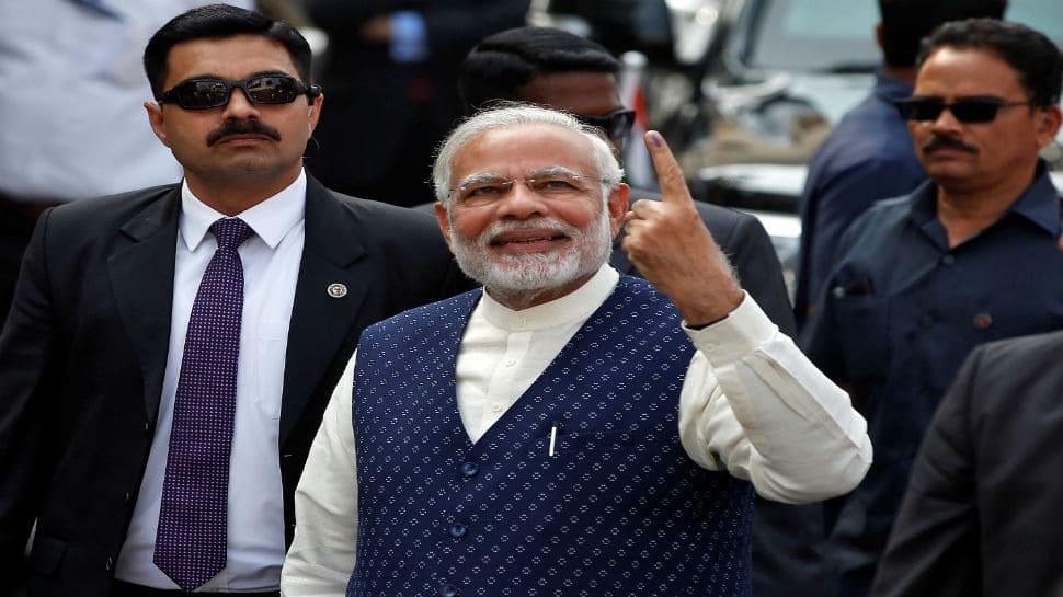 After casting his vote, he showed his inked finger to thousands of supporters who had gathered outside and were chanting 