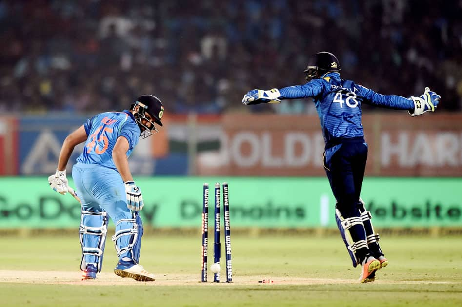 Indian captain Rohit Sharma gets clean bowled out by Sri Lanka's Akila Dananjaya at the 3rd and final ODI cricket match, in Vizag.