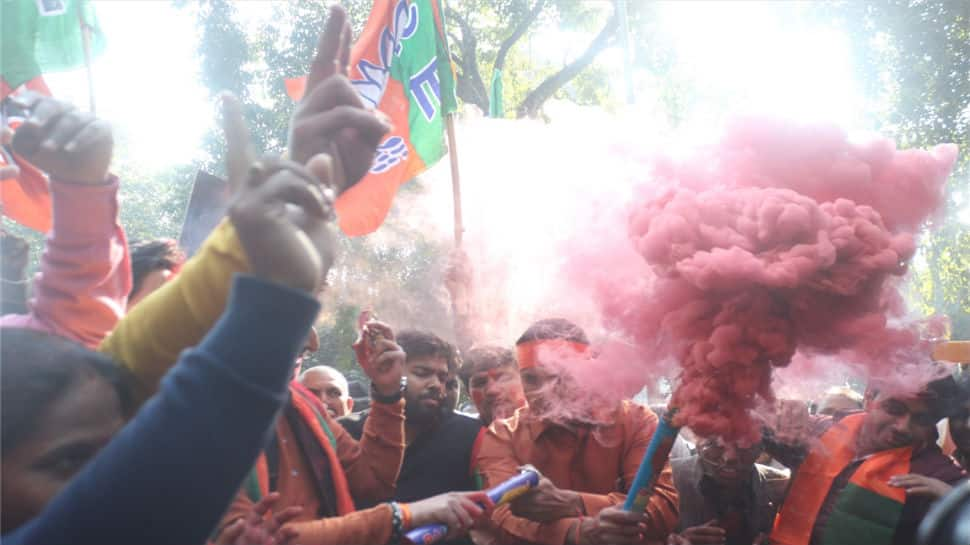 BJP workers celebrate the party's performance in Himachal Pradesh and Gujarat assembly elections in New Delhi