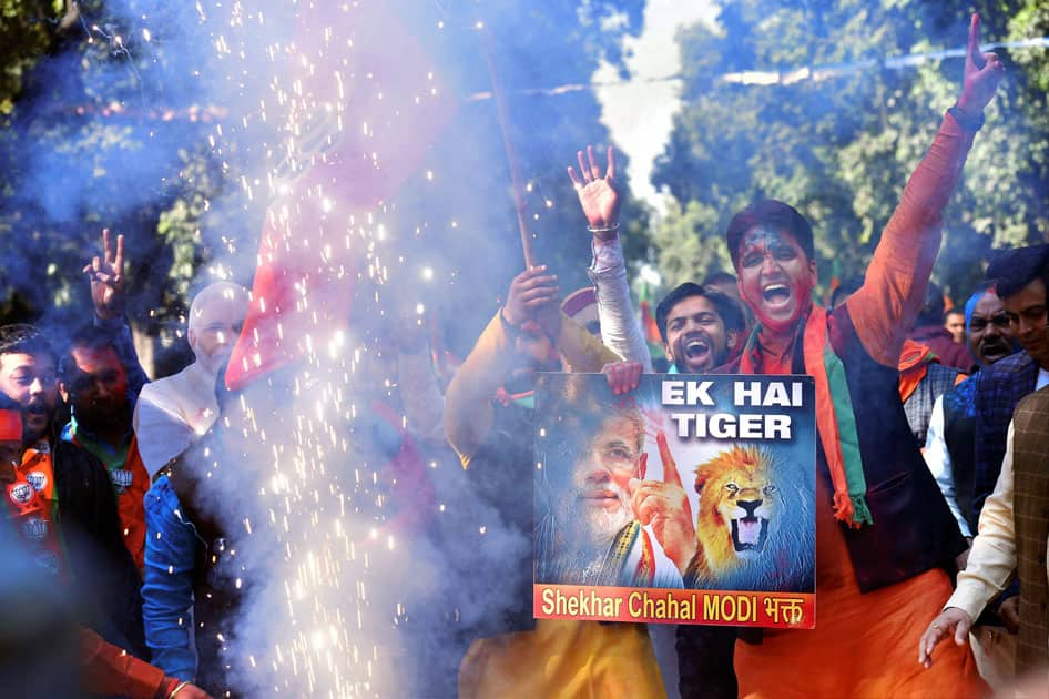 Party workers and supporters celebrating BJP's success in the state assembly elections outside the BJP headquarter, in New Delhi.