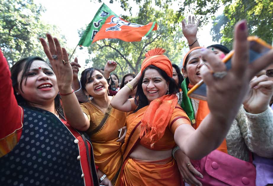 Party workers and supporters celebrating BJP's success in the Gujarat and Himachal Pradesh state assembly elections, outside the BJP headquarter, in New Delhi.