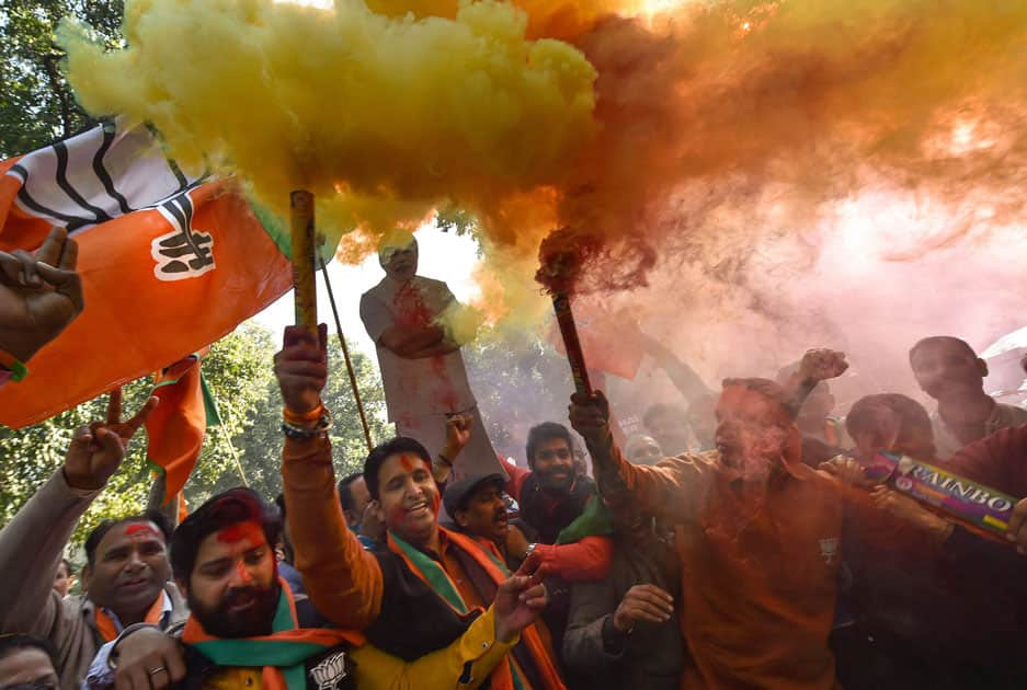 Party workers and supporters celebrating BJP's success in the Gujarat and Himachal Pradesh state assembly elections, outside the BJP headquarter in New Delhi.