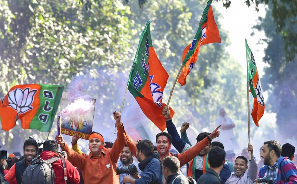 Party workers and supporters celebrating BJP's success in Gujarat and Himachal Pradesh state assembly elections outside the BJP headquarter, in New Delhi.