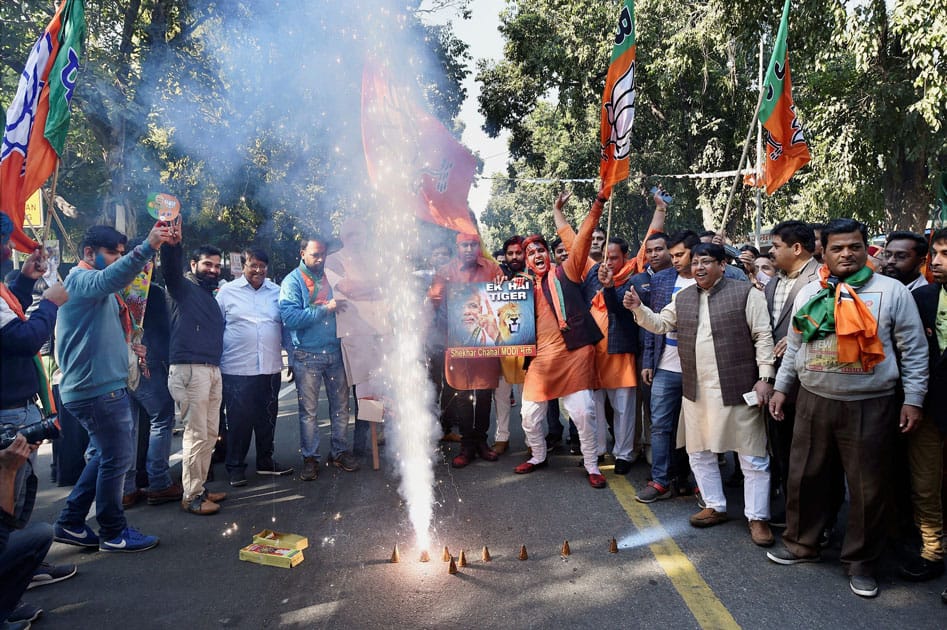 Party workers and supporters celebrating BJP's success in the state assembly elections outside the BJP headquarter, in New Delhi.