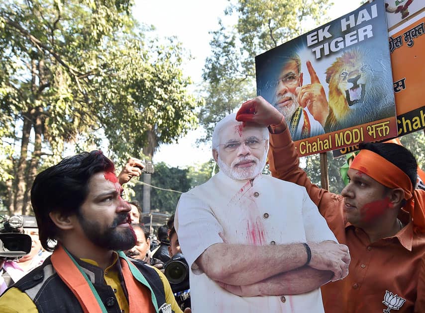 Party workers and supporters celebrating BJP's success in the Gujarat and Himachal Pradesh state assembly elections outside the BJP headquarter, in New Delhi.