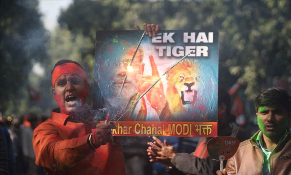 BJP workers celebrate the party's performance in Himachal Pradesh and Gujarat assembly elections, in New Delhi.