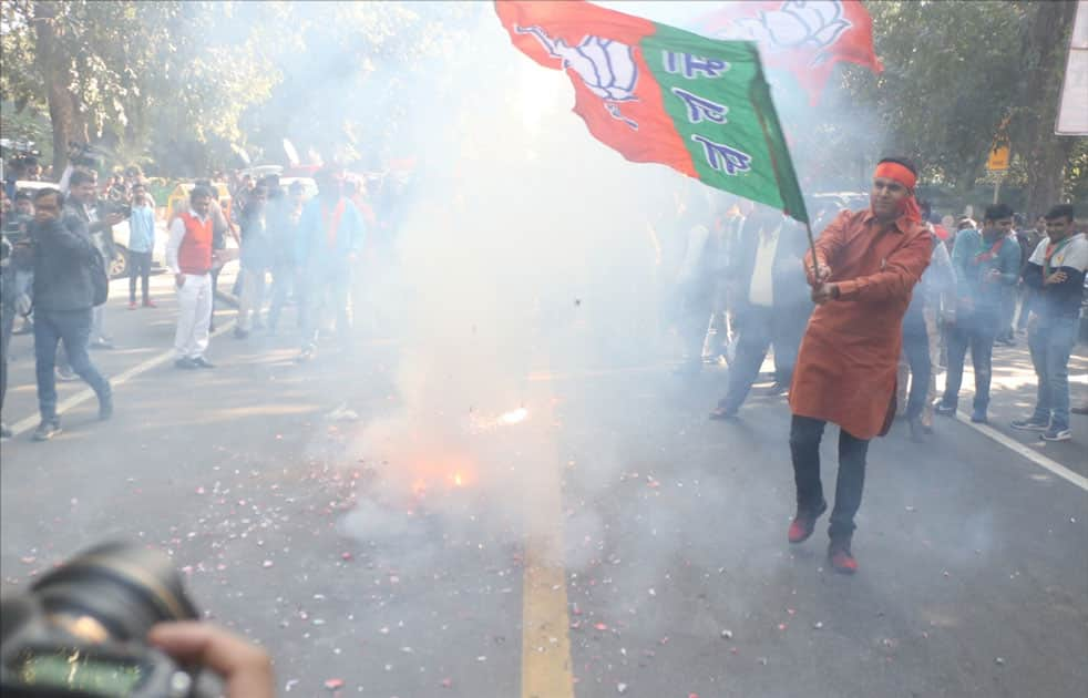 A party worker during celebrations over the party's performance in Himachal Pradesh and Gujarat assembly elections in New Delhi.